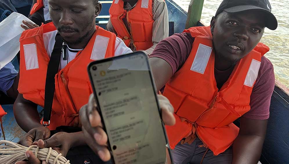 Dunga Fish farmer Didi Victor showing off text messages sent to his phone by the AI early warning system. Photo by Davis J. Weddi / SciDev.Net