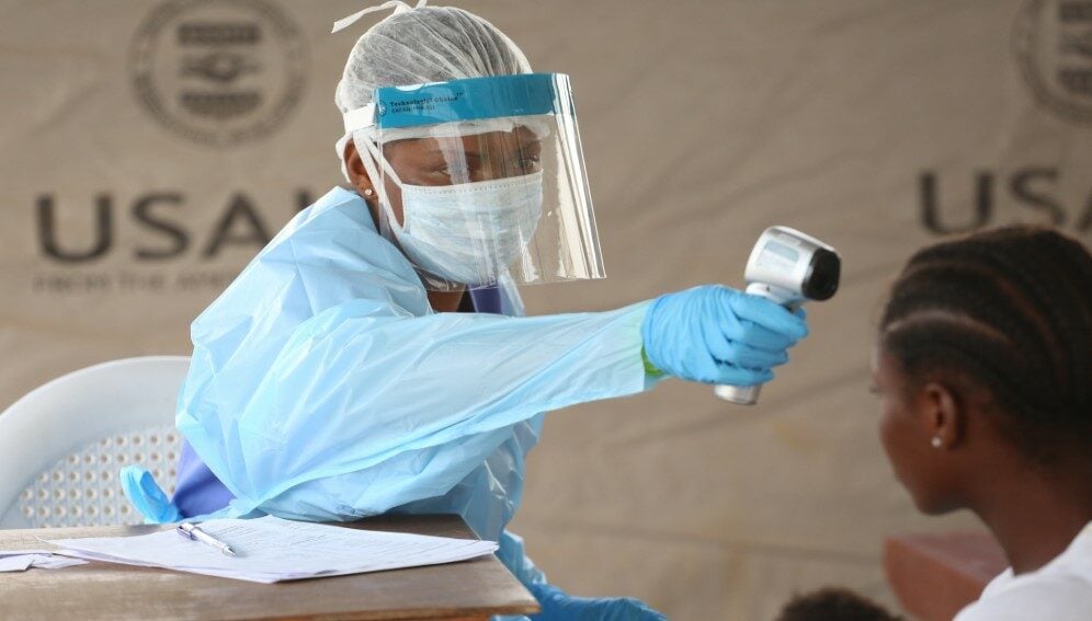 A nurse checks the temperature