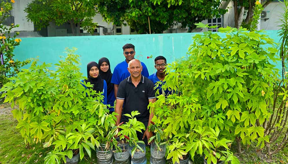 Abdulla Ahmed, Principal of Faafu Atoll Education Centre in Nilandhoo with students planting saplings. Courtesy Abdulla Ahmed