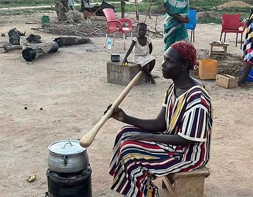 Ainatu Hakim prepares dinner for her family with the improved cookstove.