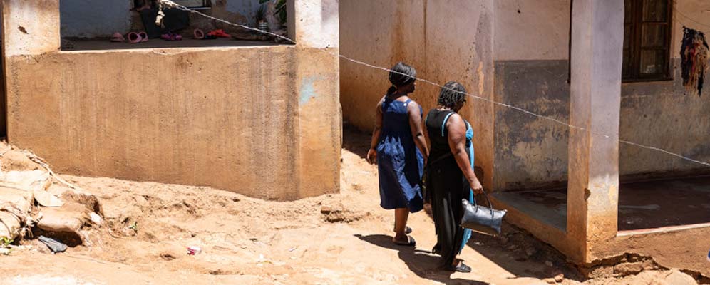 Patricia walking home with her sister. After losing her vision due to cryptococcal meningitis