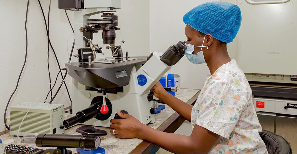 DR. Claire Nakalema a Senior Embryologist Checking sperm quality using a high-resolution microscope