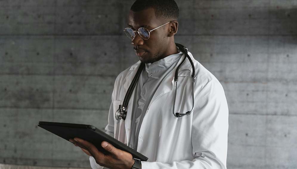 A Doctor Using a Tablet. Photo by Tima Miroshnichenko (Pexels.com)
