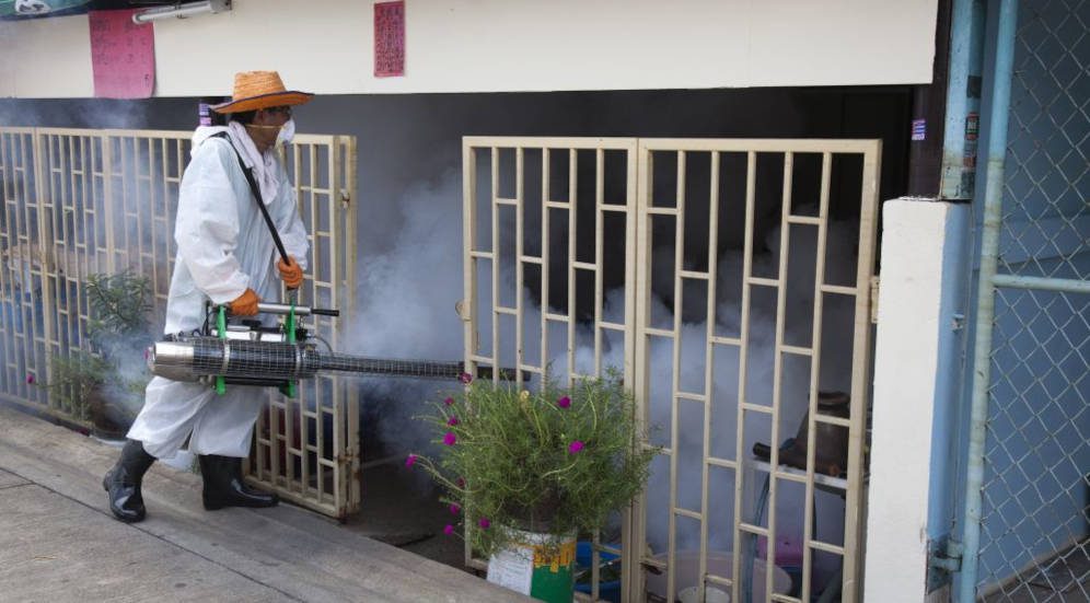 A Public Health ministry dengue prevention worker sprays mosquito repellent in a street outside Bangkok, Thailand.Copyright: Patrick de Noirmon / Sanofi Pasteur (CC BY-NC-ND 2.0)